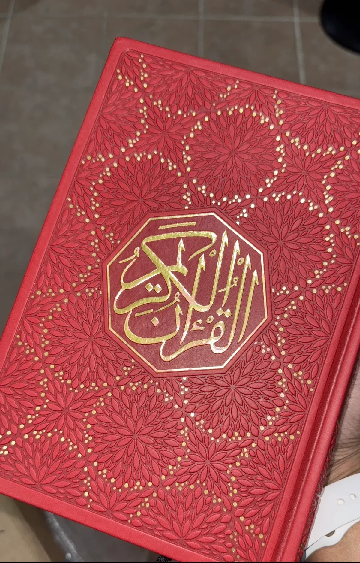Red Qur’an cover with a gold medallion